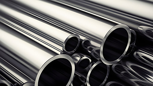A stack of stainless steel pipes with the word steel A stack of stainless steel pipes with the word steel